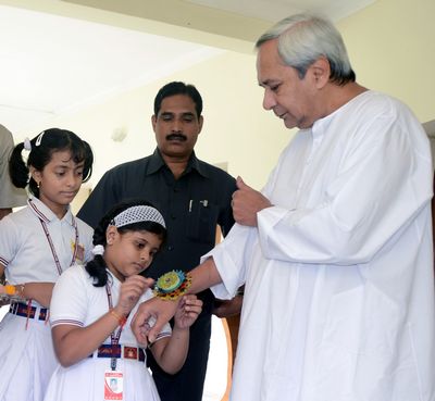 School Children tying Rakhi on the hands of Chief Minister Shri Naveen Patnaik at Naveen Newas on Date-01-Aug-2012