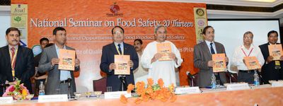 Chief Minister Shri Naveen Patnaik relishing Souvenir at the 2nd National Seminar on Food Safety 20 Thirteen at Hotel Mayfair