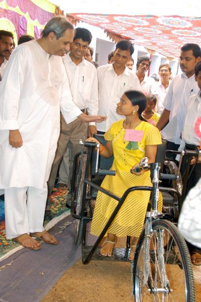 Chief Minister Shri Naveen Patnaik distributing tri-cycle at Hinjili Block.
