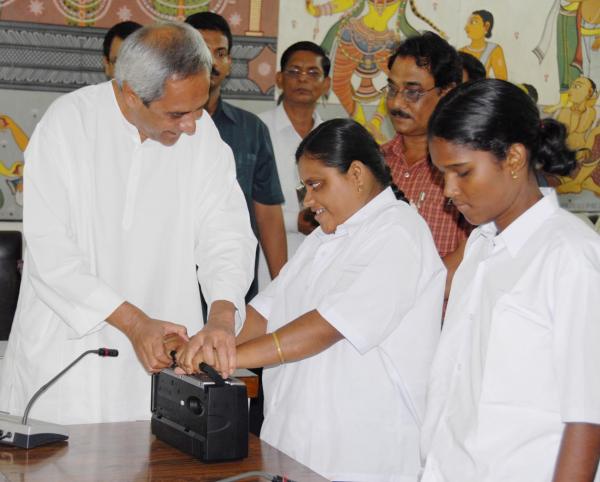 aveen Patnaik presenting  a tape-recorder to a visually challenged girl at secretariat for her success in Matriculation exam.
